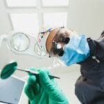 The patient's first person view at the examination by the dentist lies in the dental chair.